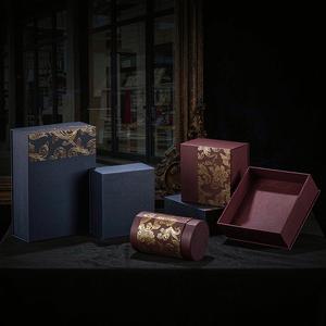 Luxury rigid gift boxes in navy and burgundy with gold accents