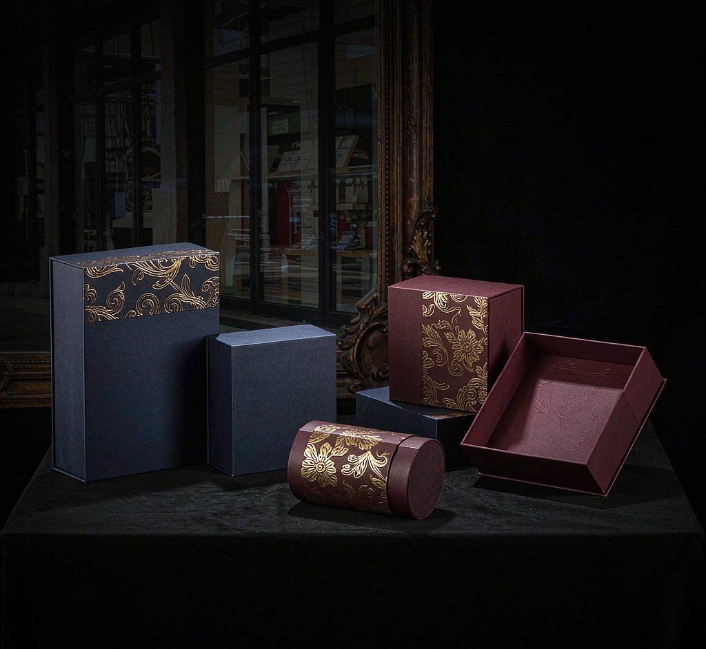Luxury rigid gift boxes in navy and burgundy with gold accents