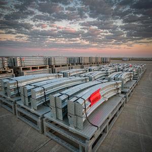 Guardrail bundles on flat export racks at a port yard