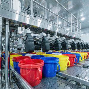 Colorful pails on a clean filling line