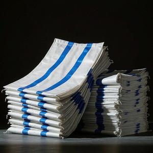 White woven PP bags with vivid blue stripes in studio light